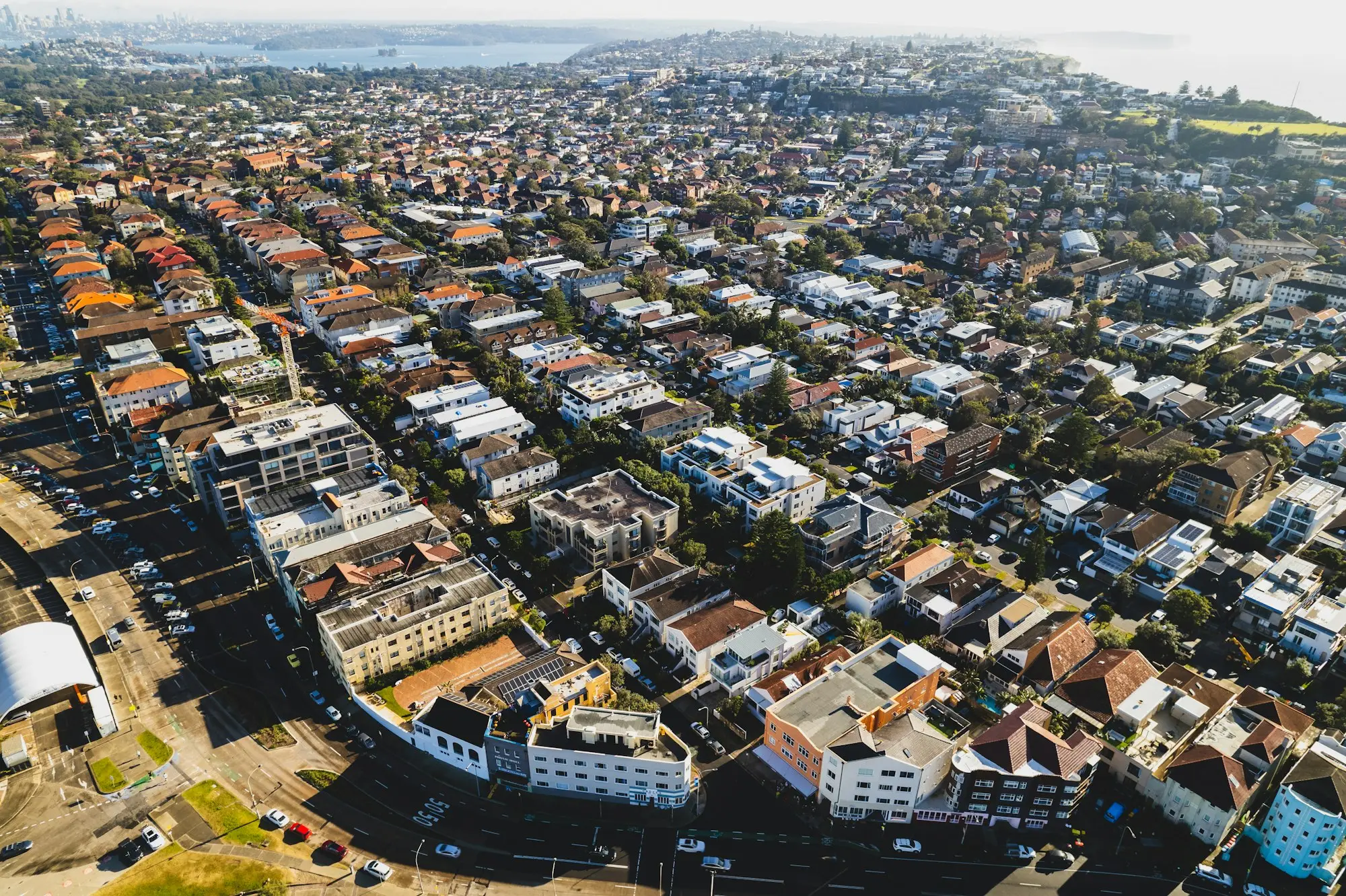 Aerial view over the terracotta rooftops of a dense Australian suburb